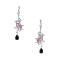 Silver-toned drop earrings with ornate rose design, pink zirconia center, and black teardrop stones on cream background