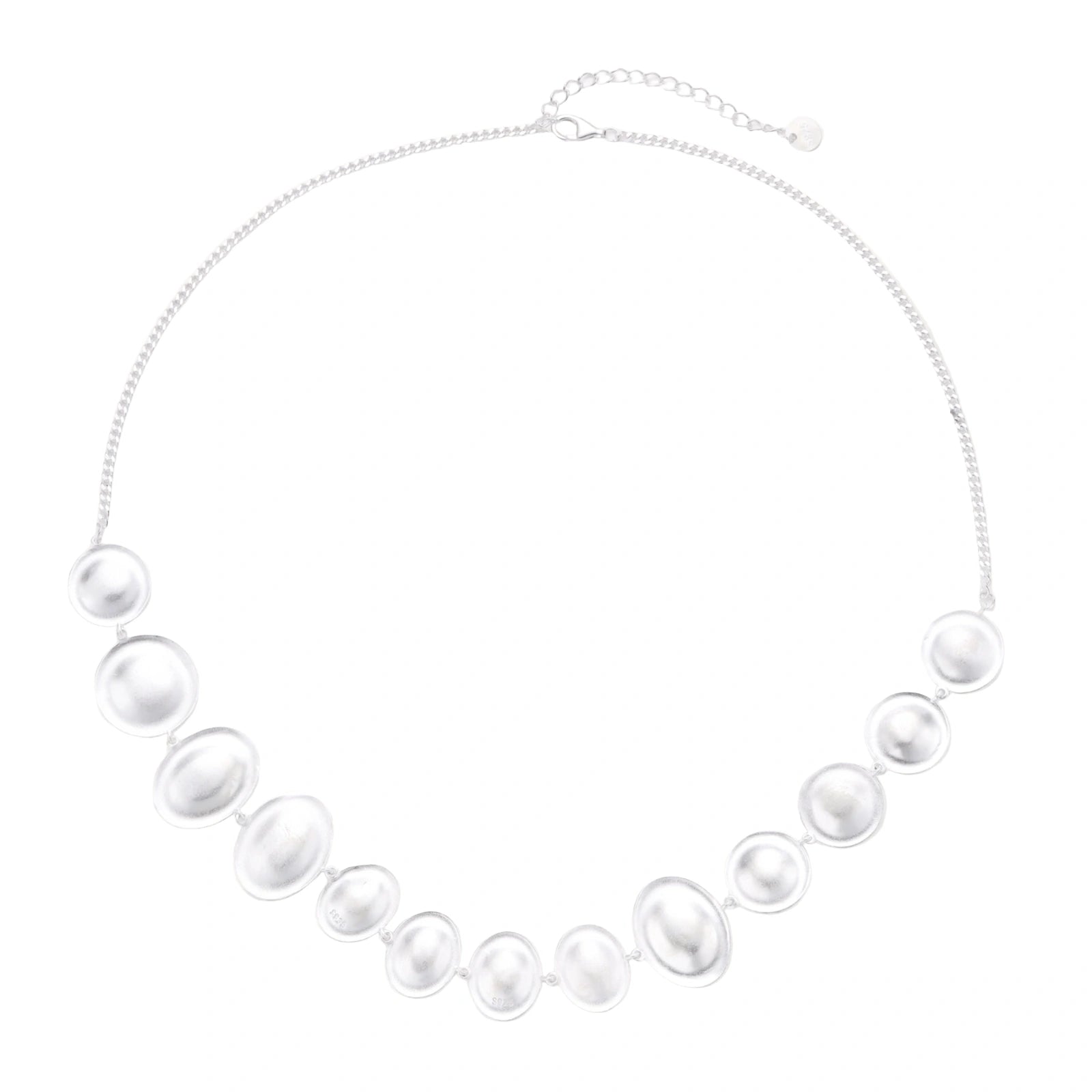 Graduated pearl-finish silver discs forming an organic bubble bib necklace on delicate chain against cream background.