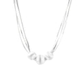 Sterling silver multi-strand necklace with three brushed round beads on cream background