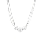 Sterling silver multi-strand necklace with three brushed round beads on cream background