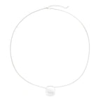 Minimalist brushed sterling silver dome pendant on delicate chain against cream background, showing matte textured finish