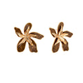 Gold-plated brass flower earrings with brown tortoiseshell enamel petals on cream background