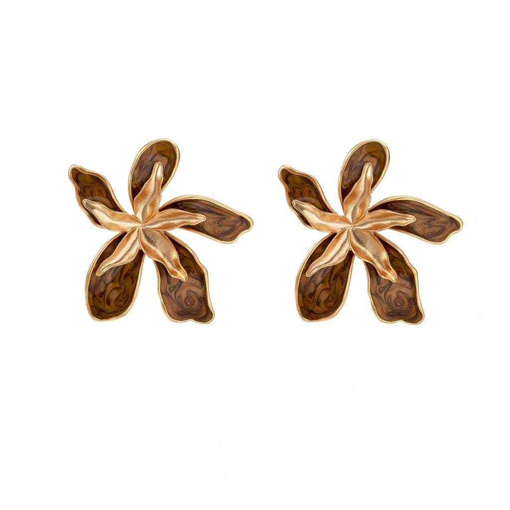 Gold-plated brass flower earrings with brown tortoiseshell enamel petals on cream background