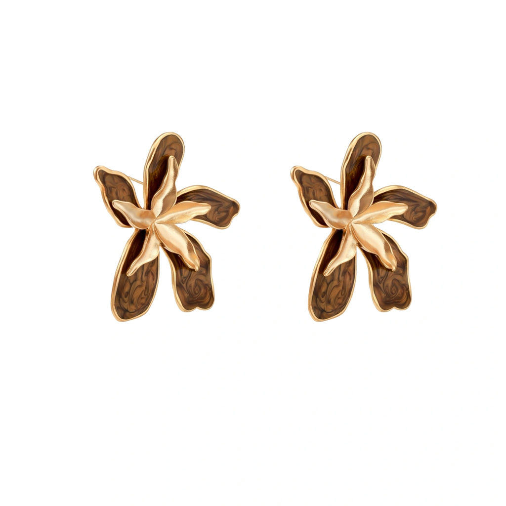 Gold-plated brass flower earrings with brown tortoiseshell enamel petals on cream background