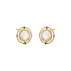 Circular gold stud earrings with iridescent mother-of-pearl center and green zirconia accents on cream background.