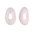 Oval lavender enamel earrings with marbled finish and gold-plated beaded border on cream background.
