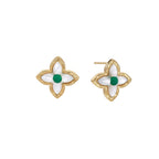 Gold quatrefoil stud earrings with white mother-of-pearl petals and emerald green gemstone center on beige background.