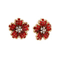 Gold-plated flower studs with burgundy square crystals in petal mosaic and clear center stones on beige background.