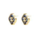 Gold quatrefoil stud earrings with iridescent abalone shell inlay and fleur-de-lis center, accented by four crystals