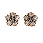 Gold-plated floral stud earrings with geometric zirconia crystals arranged in five-petal design on cream background