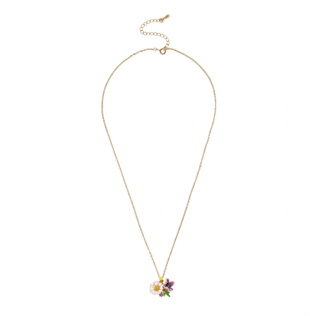 Gold-plated necklace with pink and purple enamel flower pendant featuring crystal accents on cream background