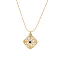 Gold filigree pendant with quatrefoil design, deep blue lapis lazuli center, clear crystal accents on ball chain