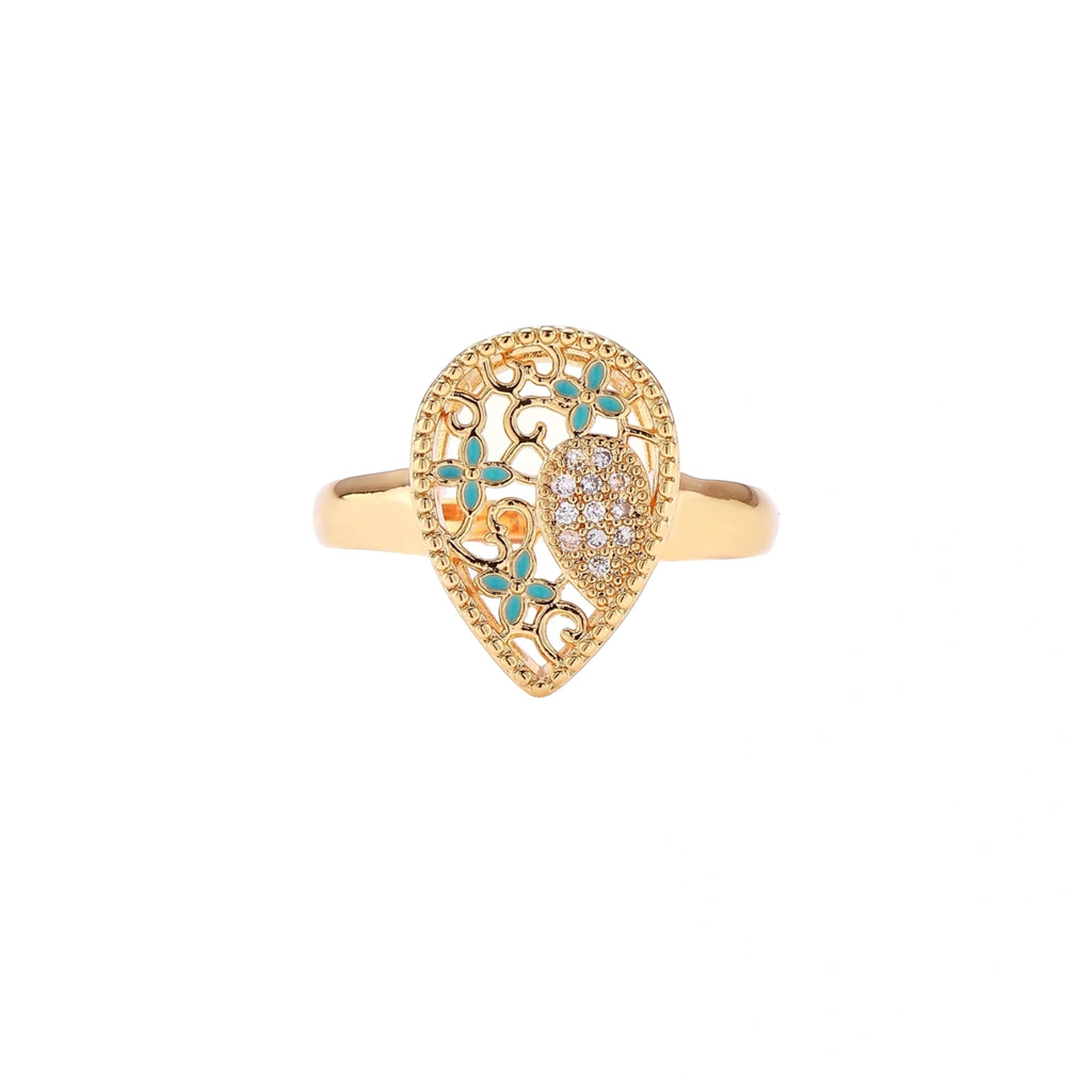 Teardrop-shaped gold-plated ring with turquoise enamel flowers and crystal pavé detail on cream background
