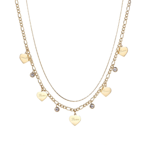 Gold layered necklace set with engraved heart pendants and crystal accents on cream background