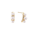 14K gold-plated curved stud earrings with three white freshwater pearls aligned vertically on cream background