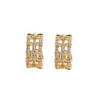 Gold-plated geometric hoop earrings with basket-weave lattice design and pavé crystal accents on cream background