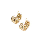 Gold-plated geometric hoop earrings with basket-weave lattice design and pavé crystal accents on cream background
