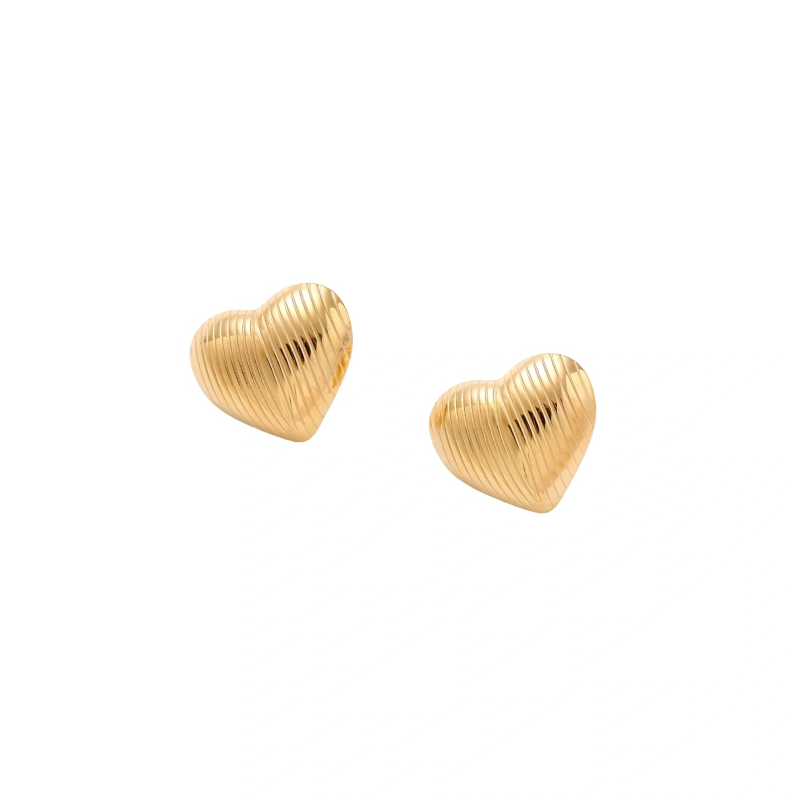 Gold heart-shaped stud earrings with parallel ridged texture on cream background