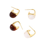 Modern drop earrings with curved gold-plated copper tops and amber resin bottoms creating an organic teardrop silhouette.