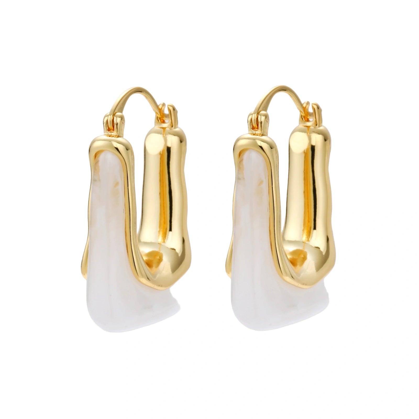 Sculptural gold-plated hoop earrings with flowing curved design and lever-back closure on cream background.