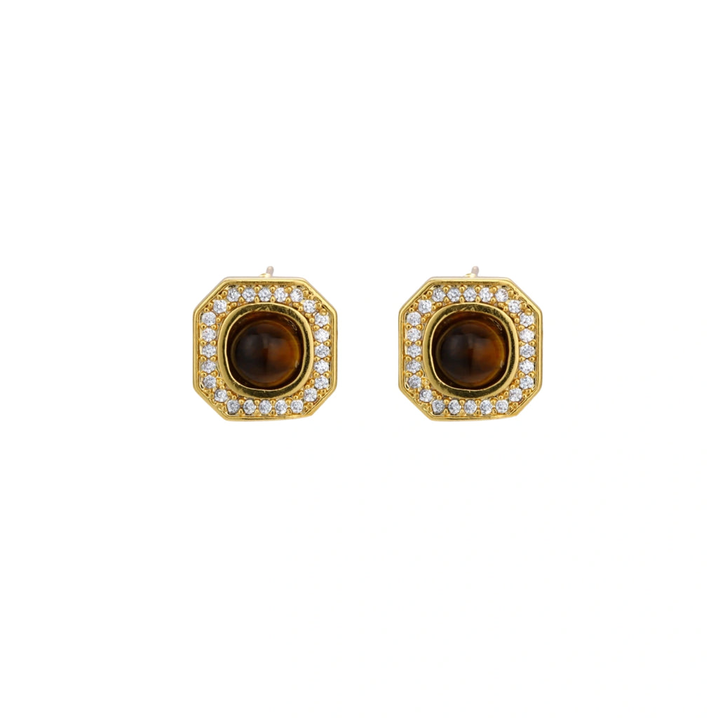 Gold-plated octagonal stud earrings with brown tiger's eye centers and cubic zirconia border on cream background.