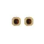 Gold-plated octagonal stud earrings with brown tiger's eye centers and cubic zirconia border on cream background.