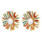 Vibrant starburst stud earrings with multicolor enamel rays and white pearl centers on gold-plated setting
