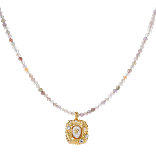 Ornate gold-plated pendant necklace with multicolored gemstone beads in purple, pink and clear tones on white background