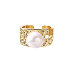 Wide gold-plated ring with organic textured band and white freshwater pearl centerpiece