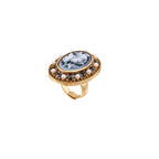 Gold-plated ring with oval blue floral cameo, pearl accents, and black enamel detailing on white background.