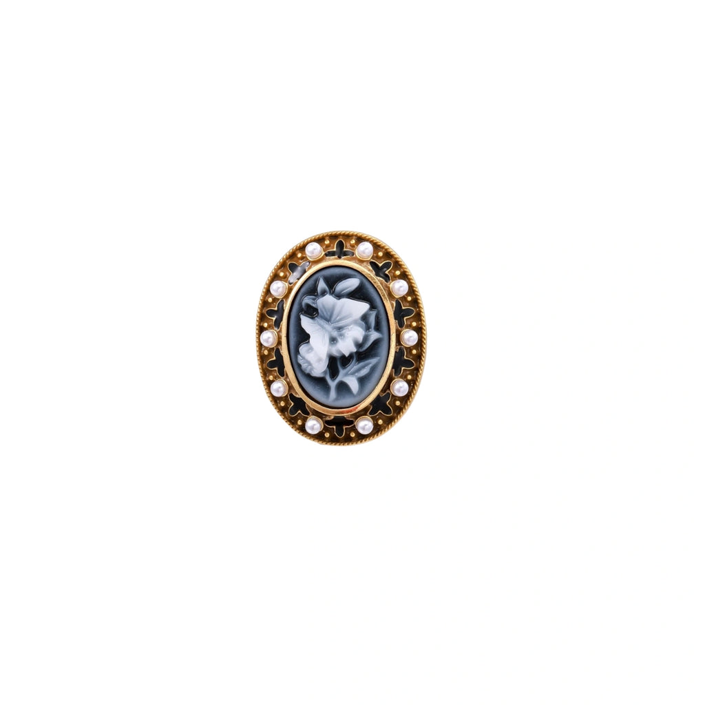 Gold-plated ring with oval blue floral cameo, pearl accents, and black enamel detailing on white background.