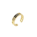 Gold-plated adjustable ring with twisted chain band, central cubic zirconia stone surrounded by crystal halo on cream background