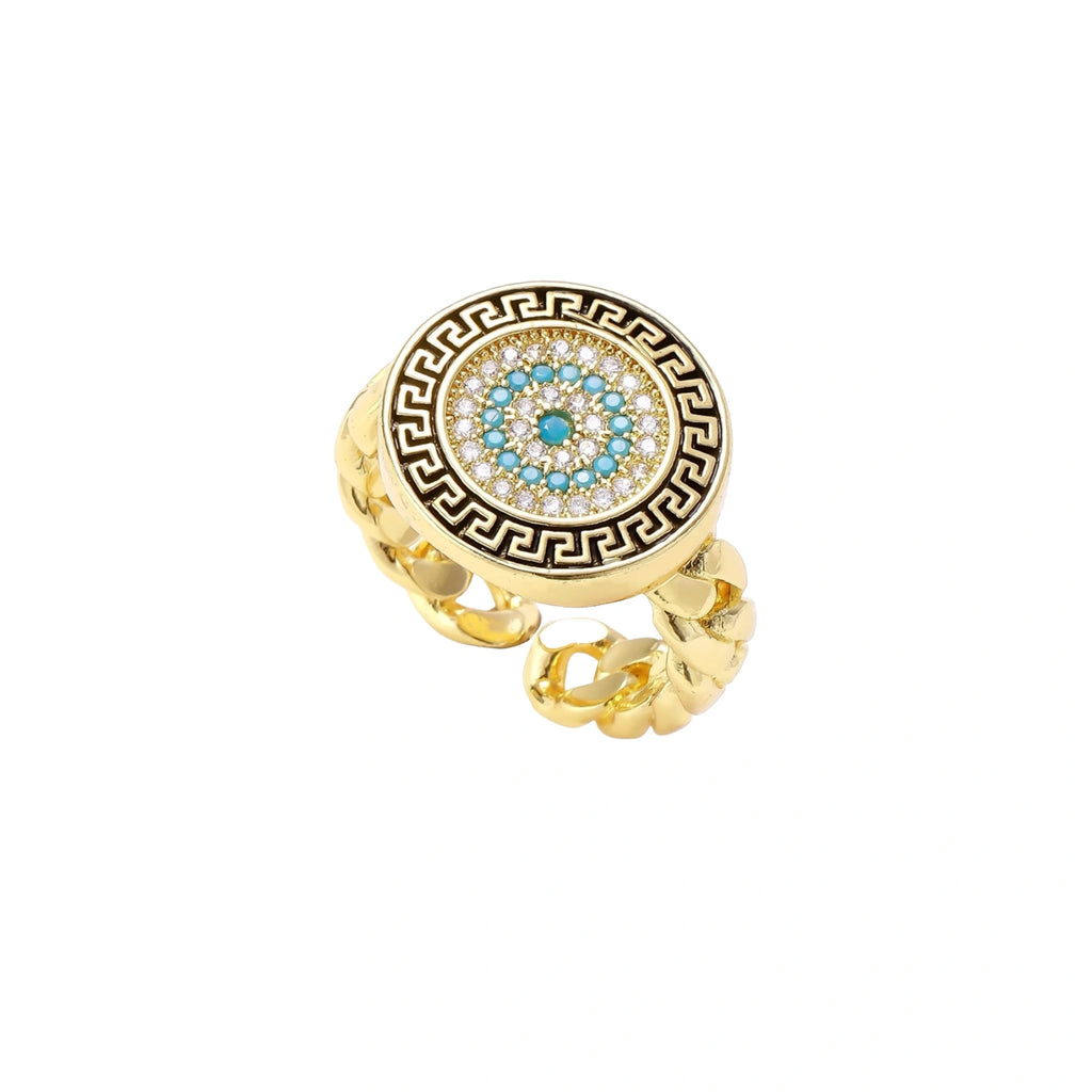 Gold chain ring with Greek key border and turquoise evil eye center on white background