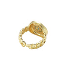 Gold chain ring with Greek key border and turquoise evil eye center on white background