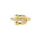 Gold-plated brass ring with safety pin design featuring pavé cubic zirconia stones and dual sphere ends