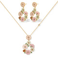 14K gold plated jewelry set with pink and green cubic zirconia flowers arranged in wreath design on cream background