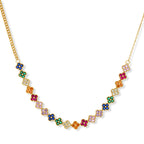 Colorful four-leaf clover jewelry set with rainbow cubic zirconia stones in gold-plated setting on white background